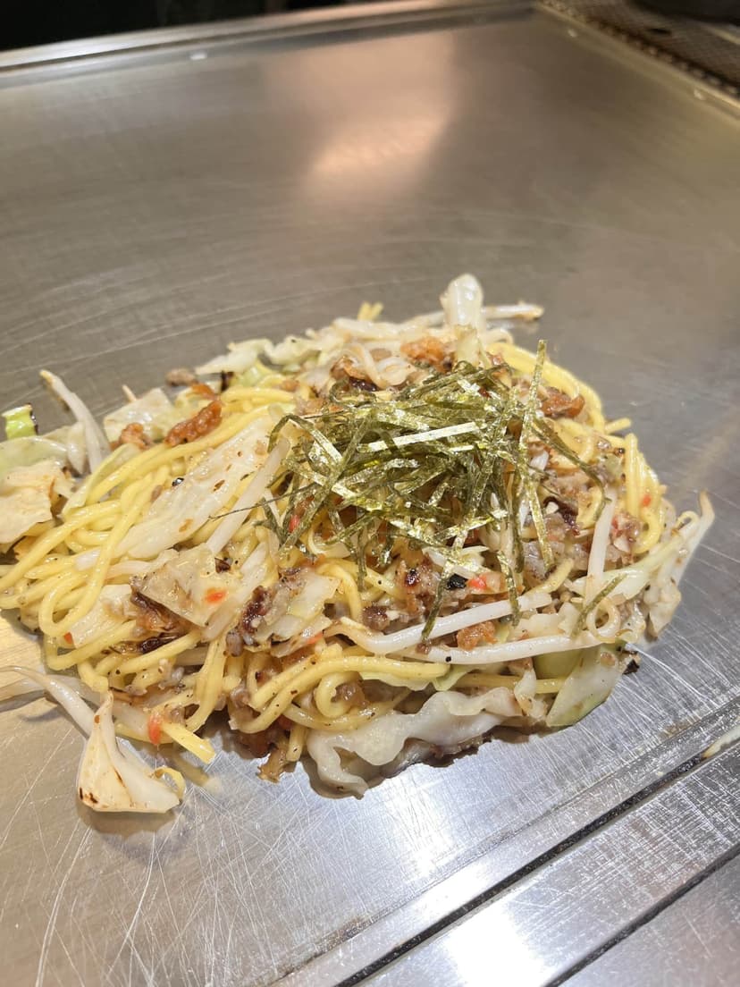 The yakisoba on the griddle in front of us