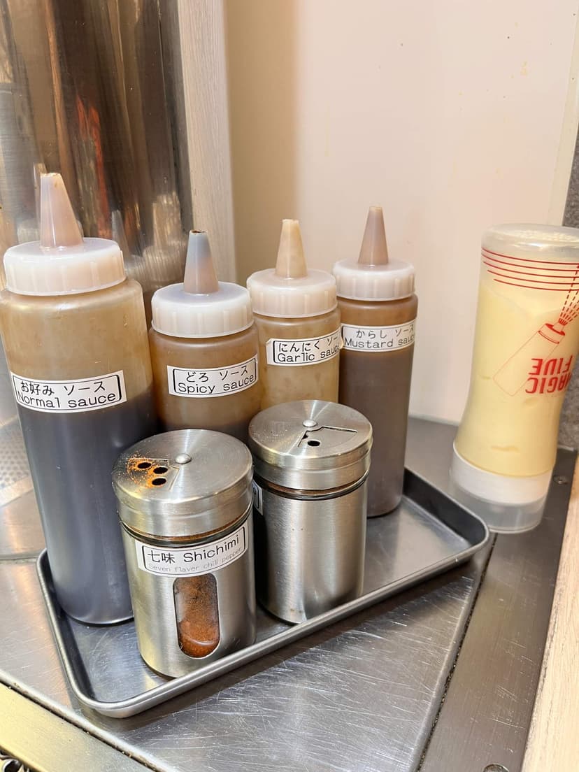 The sauce tray on the counter: the house sauce, spicy sauce, garlic sauce, mustard and shichimi