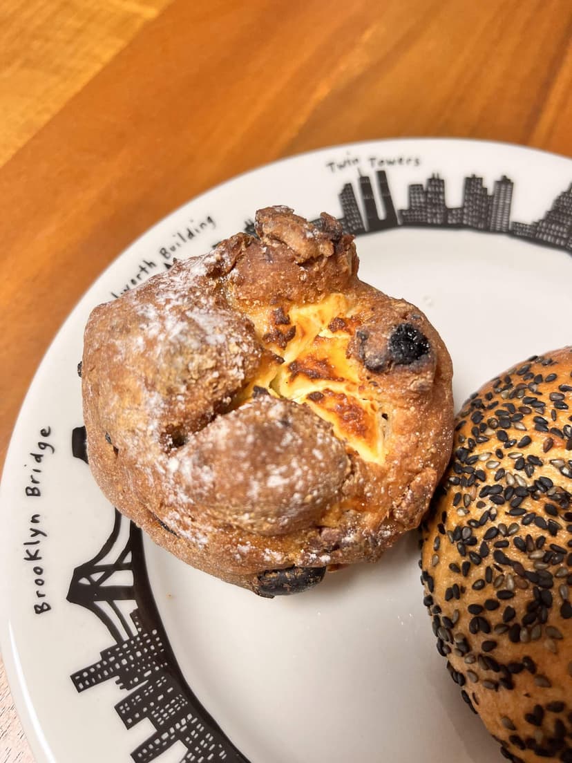 The brown-rice cream cheese bun with raisins and walnuts, with cream cheese showing through the top