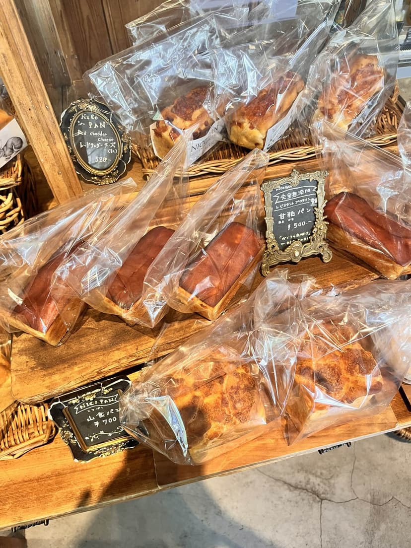 Packaged loaves on the shelf with hand-written price cards