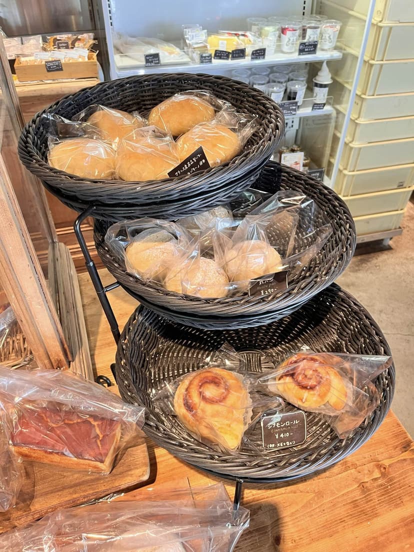 Baskets of packaged rolls and cinnamon rolls by the counter